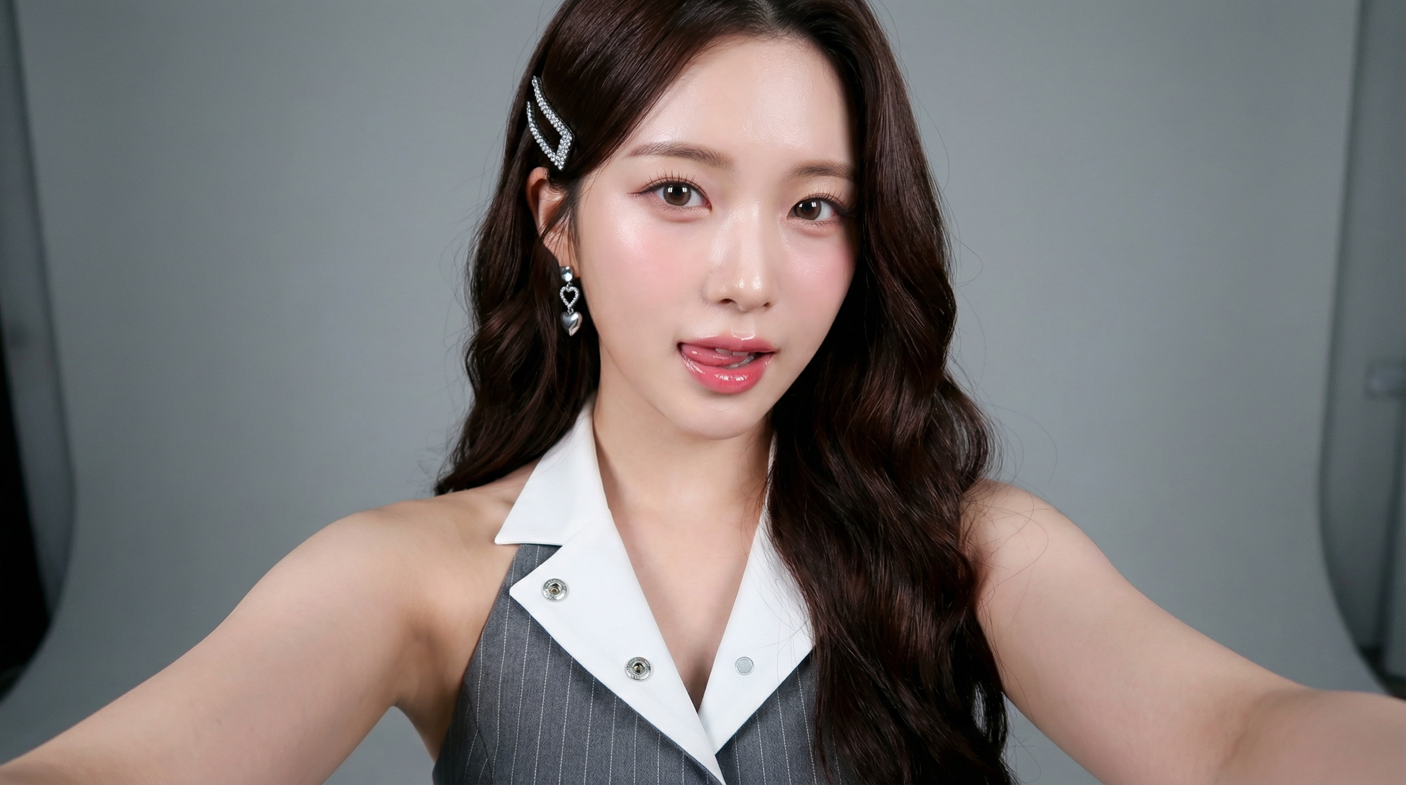 Professional studio headshot in 4K resolution, young Asian woman in sleeveless gray pinstripe vest w